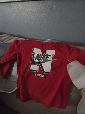 Nike Red Long-Sleeve Kids Top with Bold White Swoosh Graphic